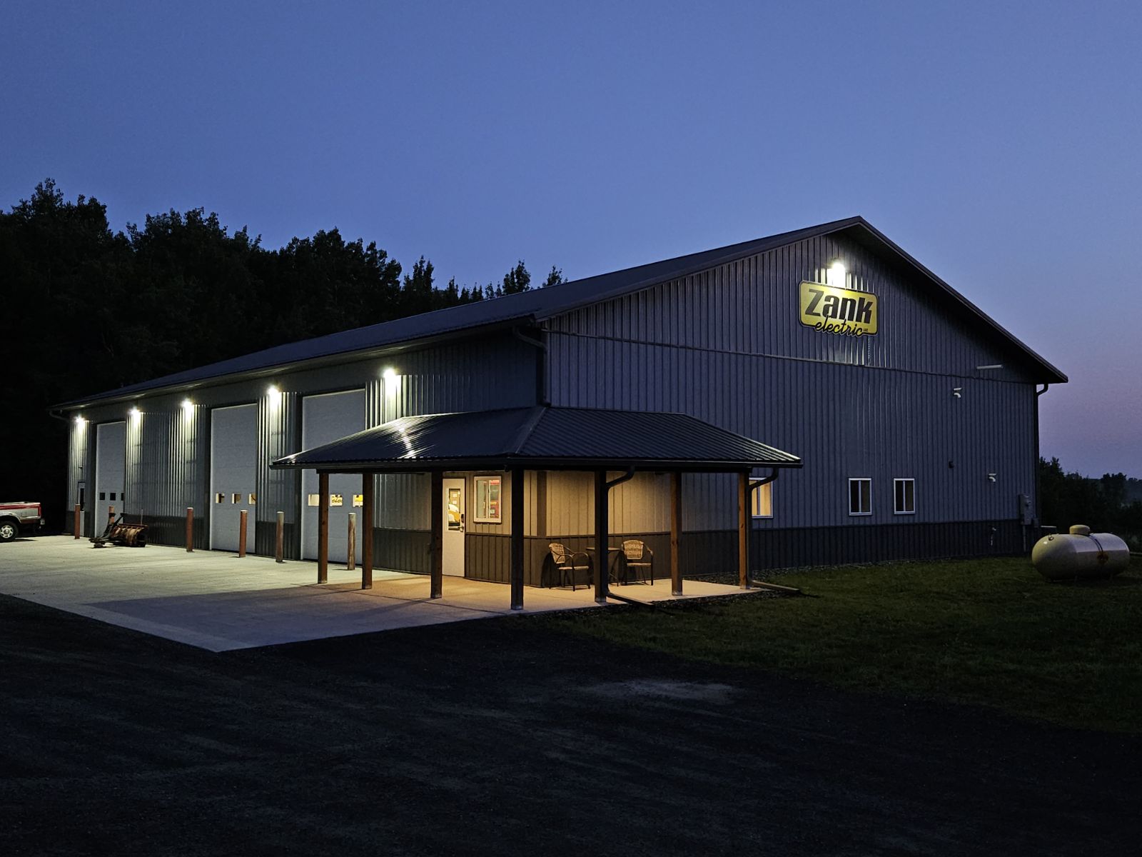 Zank Electric shop and yard at twilight — Chippewa Falls, WI